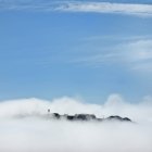 Rocky land obscured by white clouds in blue sky, San Francisco, California, United States — Stock Photo