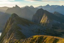 Aerial view of people and tent perched on ridge in dramatic peaks of Senja Island, Troms, Norway, Europe. — Stock Photo