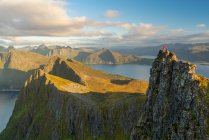 Man standing at top of pinnacle in landscape of Senja Island, Troms, Norway, Europe. — Stock Photo