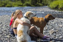 Teenage girl embracing dog in Crested Butte, Colorado, USA. — Stock Photo