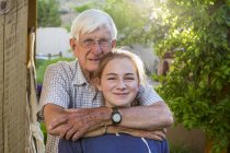 Portrait of teen girl and senior grandfather, — Stock Photo