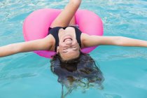 Smiling teenage girl in colorful floatie. — Stock Photo