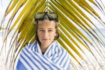 Девочка-подросток в очках перед пальмовыми листьями . — стоковое фото