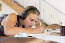 Teenage girl at home wearing headphones as painting. — Stock Photo