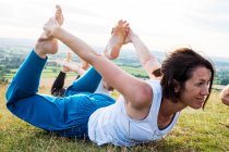 Donna matura che partecipa a lezioni di yoga all'aperto su una collina . — Foto stock