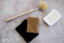 High angle view of wooden washing brush, soap and sponges. — Stock Photo