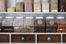 Close-up of shelves with a selection of pasta, legumes and grains in glass jars. — Stock Photo
