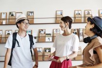 Group of Japanese professionals talking to each other in a co-working space. — Stock Photo