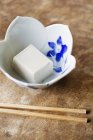 High angle close-up of bowl of tofu on a table in Japanese restaurant. — Stock Photo