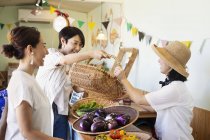 Japanese women shopping fresh vegetables in a farm shop. — Stock Photo