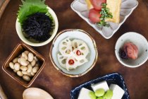 High angle close-up of a selection of vegetarian Japanese food plates in a cafe. — Stock Photo