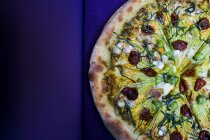 High angle close-up of vegetarian pizza with goat cheese and zucchini flowers. — Stock Photo