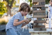 6 year old boy playing with giant jigsaw puzzle — Stock Photo
