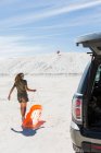 Teenage girl with sled, White Sands National Monument, NM — Stock Photo