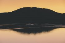 Silhouette of Black Mountain at dawn, Tamales Bay in foreground, Point Reyes National Seashore, California — Stock Photo