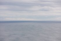 Ampia vista dell'oceano, orizzonte e nuvole temporalesche di compensazione, crepuscolo — Foto stock