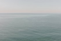View of calm ocean water, horizon and sky at dawn, northern Oregon coast — Stock Photo