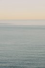 View of calm ocean water, horizon and sky at dawn, northern Oregon coast — Stock Photo
