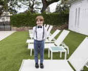 6 year old boy standing on lawn chair — Stock Photo