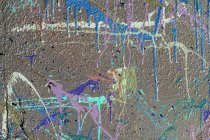 Colorful graffiti paint splatters on urban wall, abstract background — Stock Photo