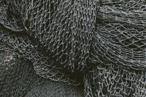 Close-up view of pile of commercial fishing nets and gillnets on a fishing quay — Stock Photo