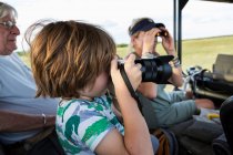 5 year old boy photographing, Moremi Reserve, Botswana — Stock Photo