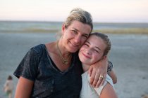Woman a young teenage girl, a mother and her daughter hugging, a family holiday. — Stock Photo