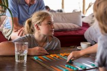Family on vacation, people playing backgammon at a tented camp in a wildlife reserve. — Stock Photo