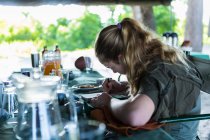 13 year old girl writing in her journal, tented camp, Botswana — Stock Photo