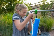 11-летняя девочка чинит качели на заднем дворе — стоковое фото