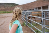 Дівчина-підліток дивиться на коня в головоломці — стокове фото
