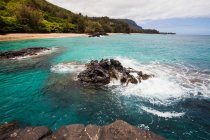 Bay and headland with rocky shore, sand and turquoise water. — Stock Photo