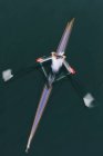 A single scull boat and rower on the water, view from above. Motion blur — Stock Photo