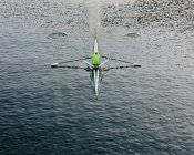 A single scull boat and rower on the water, view from above. — Stock Photo