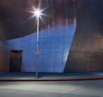Urban scene, pavement, concrete blocks wall and light in darkness — Stock Photo