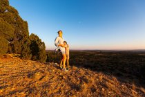 Teenage girl embracing her younger brother in the Galisteo Basin, Santa Fe, NM. — Stock Photo