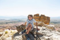 Boy hiking to the top of Chimney Rock landmark in a protected canyon landscape — Stock Photo