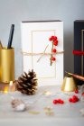 Christmas decorations, close up of golden Christmas decorations, presents and pine cone. — Stock Photo