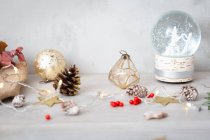 Close up view of Christmas decorations and snow globe. — Stock Photo