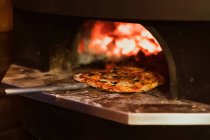 Großaufnahme einer Pizza im Holzofen in einem Restaurant. — Stockfoto