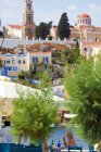 Symi Town, elevated view, rooftops, terraces, restaurant, people in the background — Stock Photo