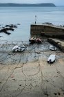 High angle view of fishing boats moored in harbour at low tide. — Stock Photo