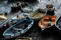 High angle view of fishing boats moored in harbour at low tide. — Stock Photo