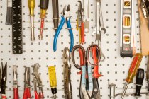 Peg board with tools arranged. — Stock Photo