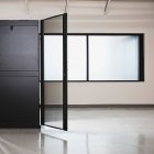 Computer server cabinet with door open and window in office — Stock Photo