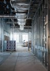Interior of construction site with exposed ducts and metal joists. — Stock Photo