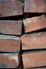 Stacked red clay bricks closeup — Stock Photo