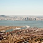 Aerial view of freight harbour with San Francisco skyline. — Stock Photo