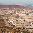 Airport with urban sprawl beyond, aerial view — Stock Photo
