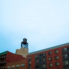 Apartment building with water tower on top. — Stock Photo